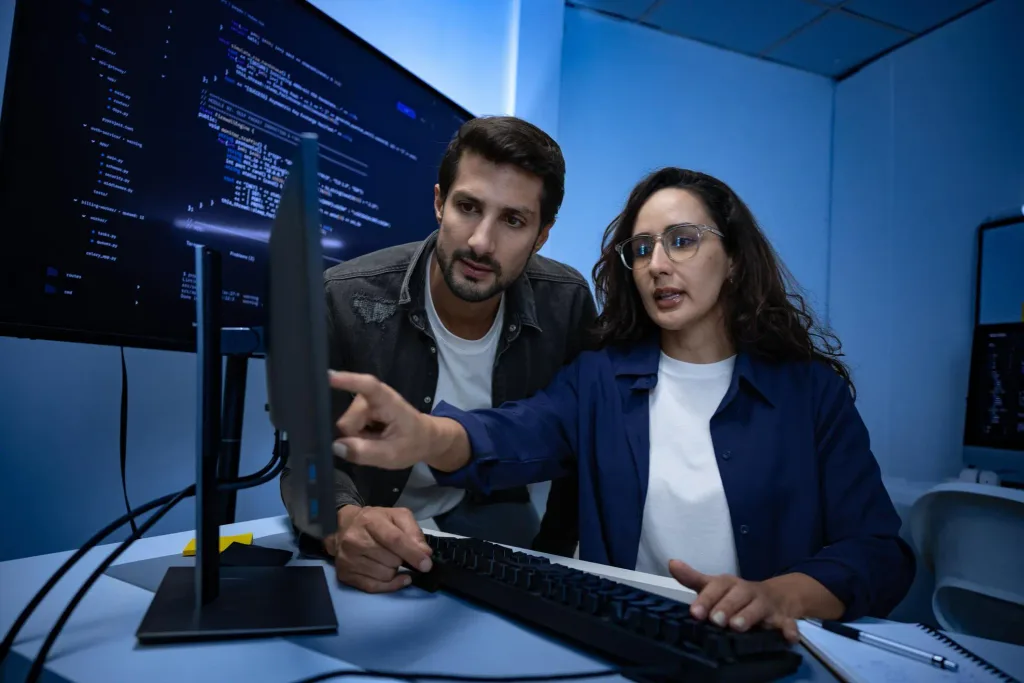Two developers reviewing unfamiliar legacy software code together